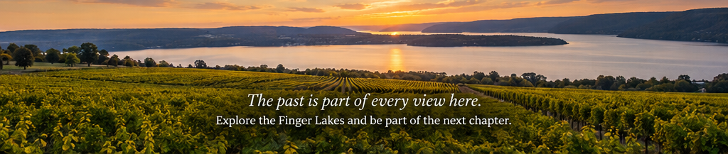 Vineyard overlooking a Finger Lake at sunset with the message, “The past is part of every view here. Explore the Finger Lakes and be part of the next chapter.”
